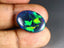 8.41 ct Oval Cabochon (19.90 x 14.47 mm) Multi Color Flashing Black Opal