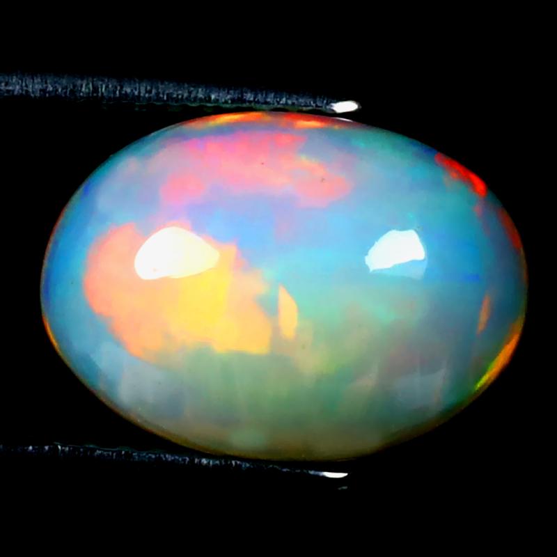 2.75 ct Pleasant Oval Cabochon (12 x 9 mm) Ethiopian 360 Degree Flashing Rainbow Opal Natural Gemstone
